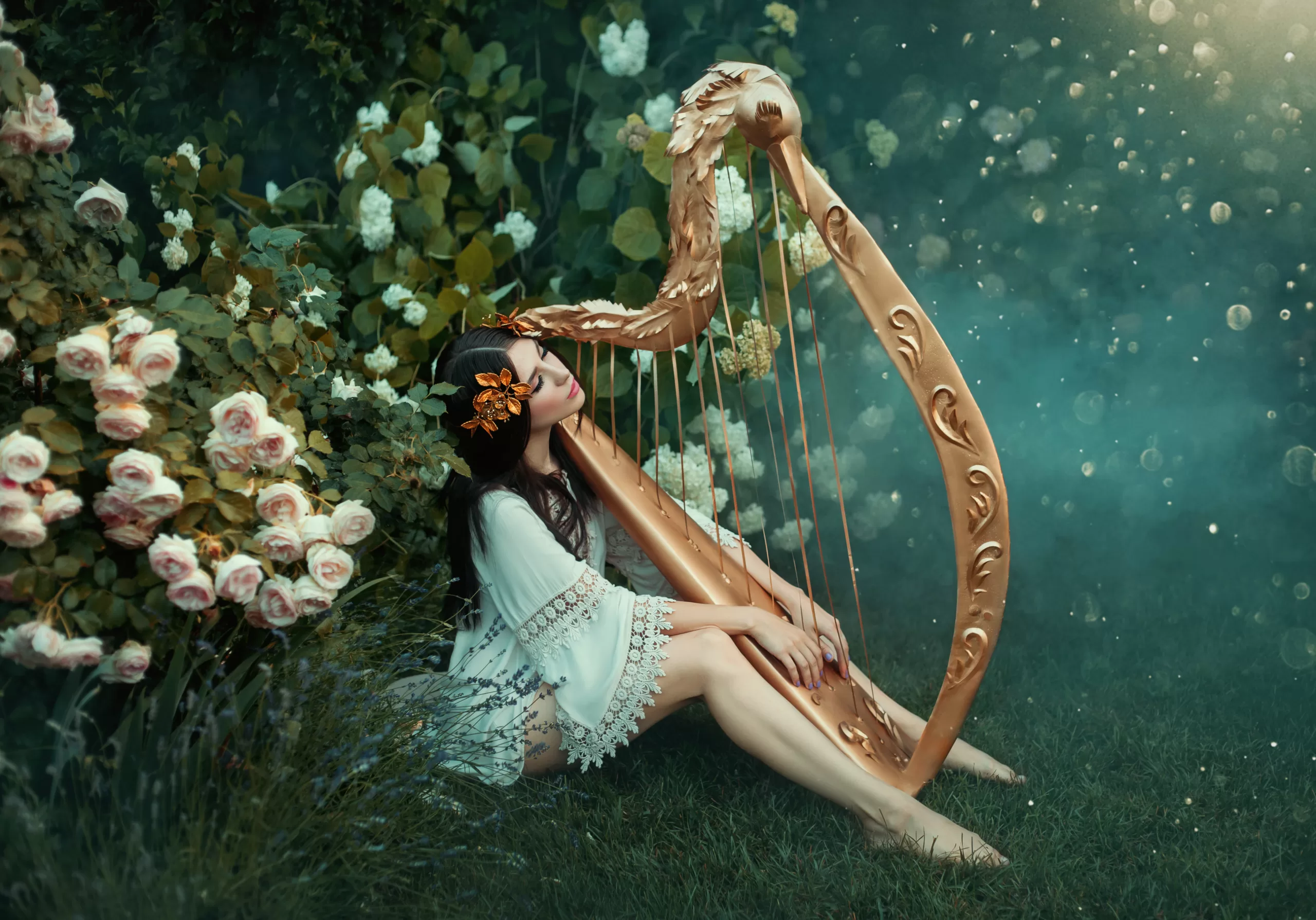 charming lady with dark black hair sits on the frozen grass alone with light white fog, forest nymph with haze plays harp, girl in simple shirt and with bare legs near rose bush, creative photo